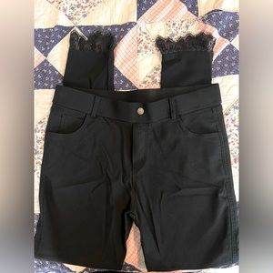 Black skinny pant with lace cuff detail.